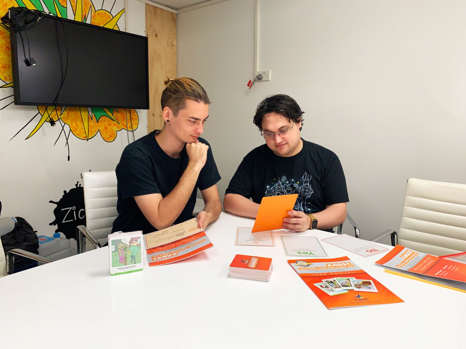 2 men reading at table